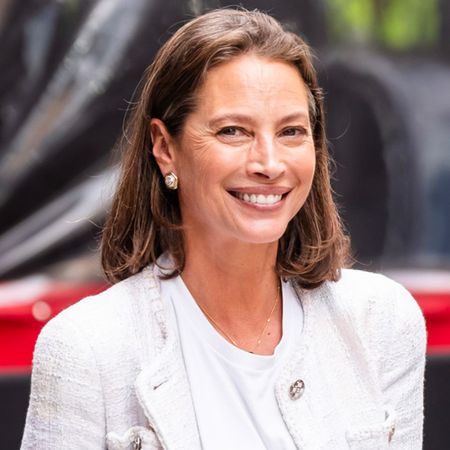 Christy Turlington at a Chanel Tribeca Film Festival lunch at Locanda Verde in NYC wearing a tweed jacket with a white T-shirt, jeans, and brown Chanel shoes.