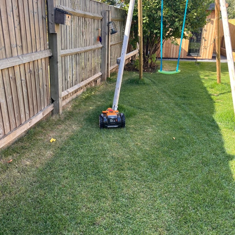LawnMaster OcuMow 16 Vision Robot Lawnmower avoiding the swing in garden