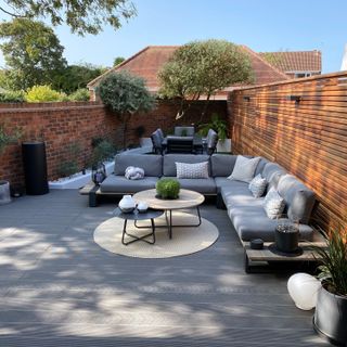 Sera Sekerci's finished garden after the transformation, with furniture, lights and decking. Her dad helped her transform her garden when trapped in the UK during lockdown