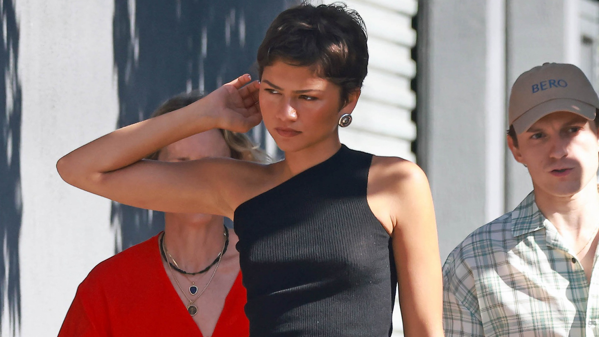 Zendaya styled a tank top with a black skirt from Prada and matching leather boots for fall