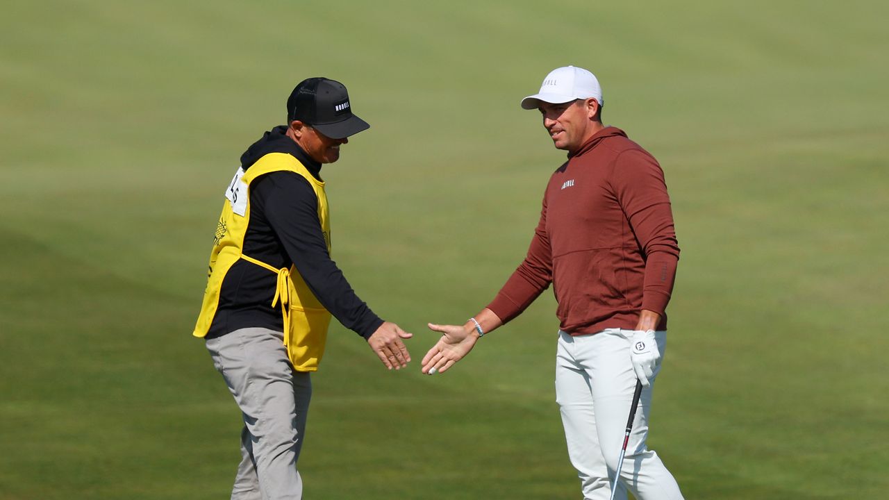 Scott Stallings celebrates with his caddie Jon Yarbrough after holing out for eagle from the tenth fairway during the first round of the 2023 PGA Championship