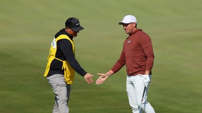 Scott Stallings celebrates with his caddie Jon Yarbrough after holing out for eagle from the tenth fairway during the first round of the 2023 PGA Championship