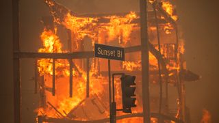  Flames from the Palisades Fire burn a building on Sunset Boulevard amid a powerful windstorm on January 8, 2025 in the Pacific Palisades neighborhood of Los Angeles, California. Fueled by intense Santa Ana Winds, the Palisades Fire has grown to over 15,000 acres and 30,000 people have been ordered to evacuate while a second major fire continues to burn near Eaton Canyon in Altadena