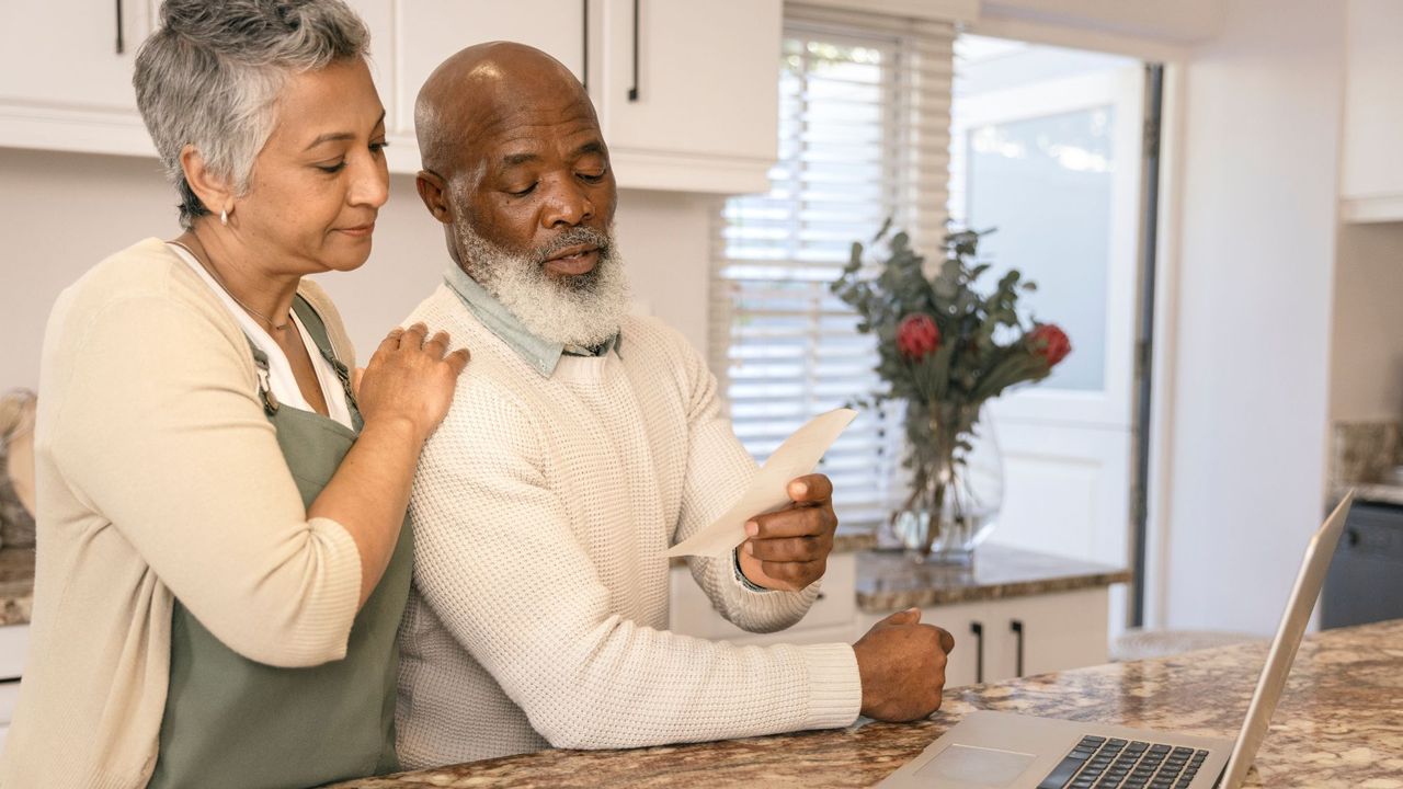 couple going over finances with vase of roses in background