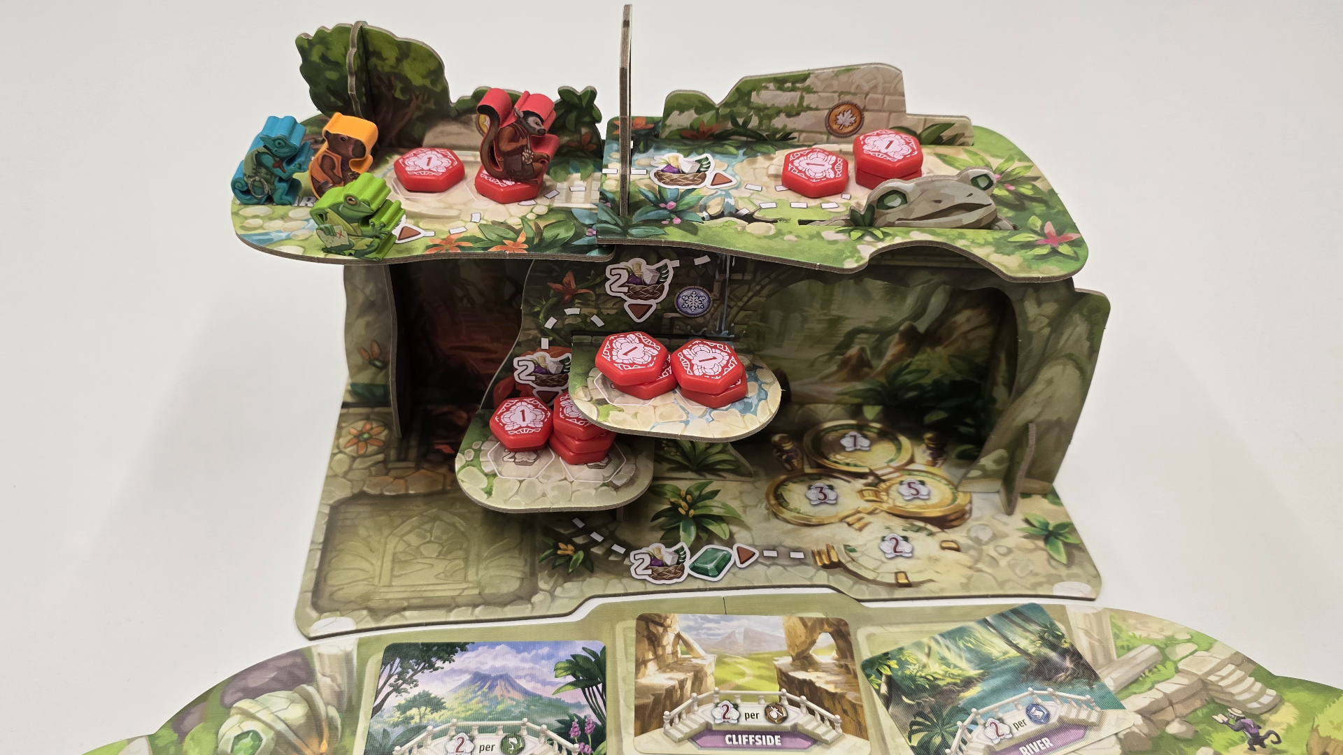 The 3D Emerland ruins, with tokens and meeple scattered across it