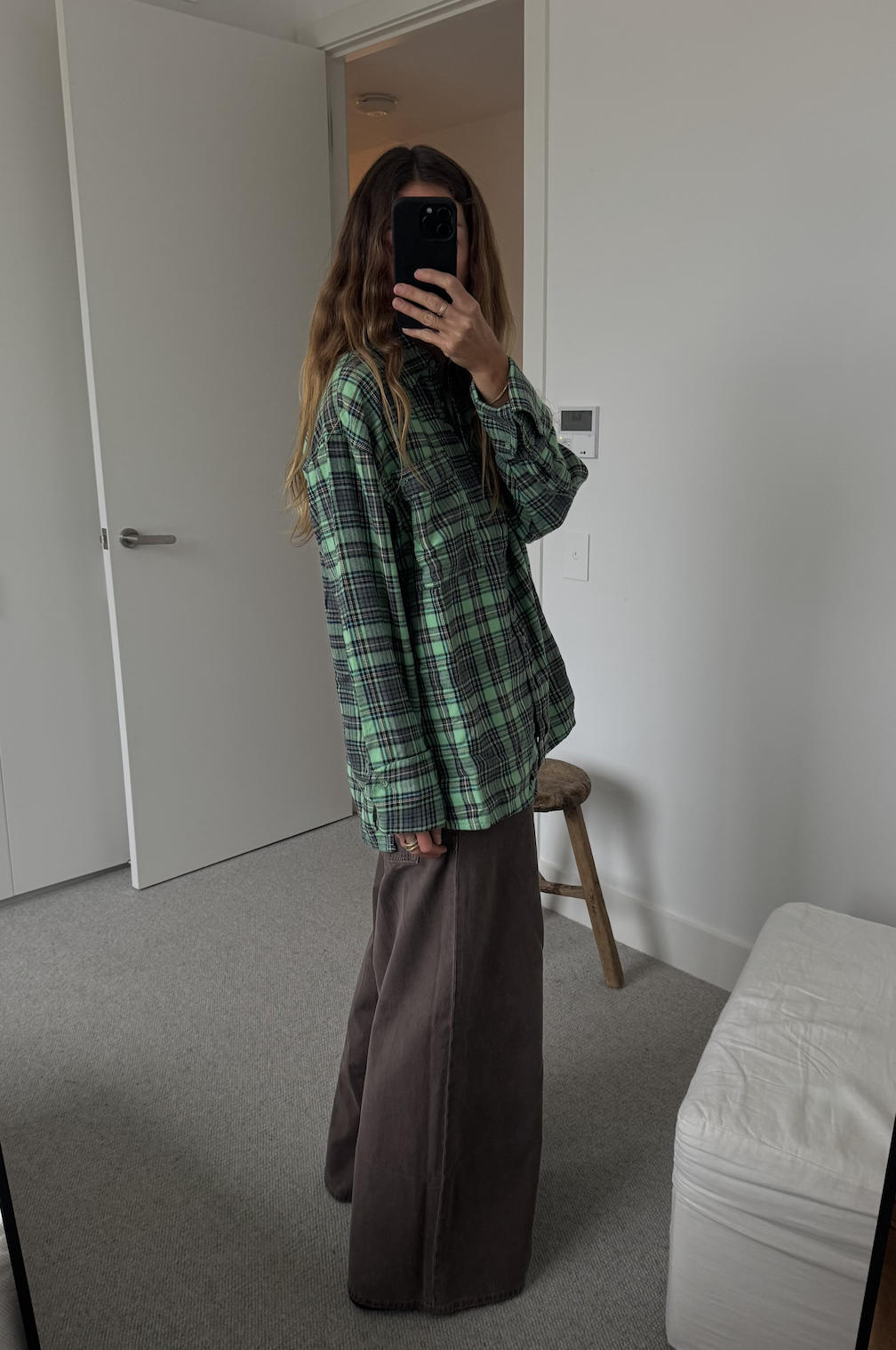 Angie wears a plaid shirt from Free People.