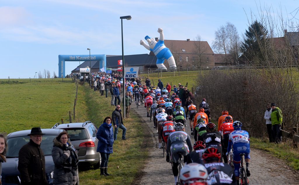 A rather large Het Nieuwsblad fan watches the race go by
