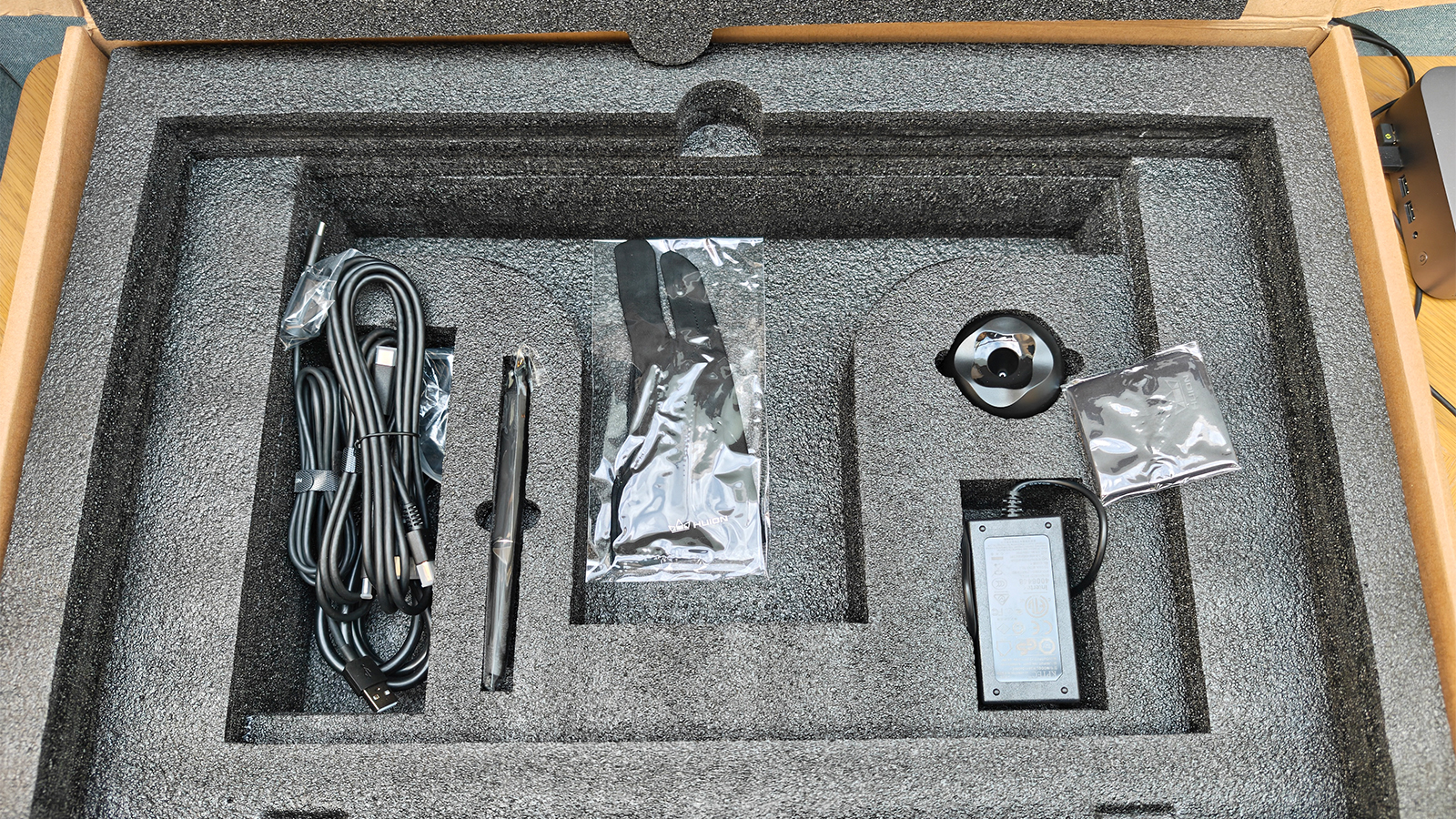 A black drawing tablet on a desk