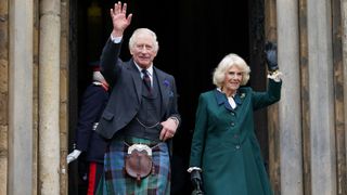 King Charles III and Camilla, Queen Consort, waves as they leave Dunfermline Abbey