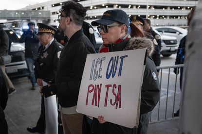 CHICAGO, ILLINOIS - MARCH 27: Demonstrators protest Department of Homeland Security assigning ICE agents to work alongside TSA agents at O'Hare International Airport on March 27, 2026 in Chicago, Illinois. The travel disruptions continue as hundreds of TSA agents quit or work without pay during a partial government shutdown. U.S. President Donald Trump said ICE agents will be deployed to U.S. airports on Monday, with border czar Tom Homan in charge of the effort. (Photo by Scott Olson/Getty Images)