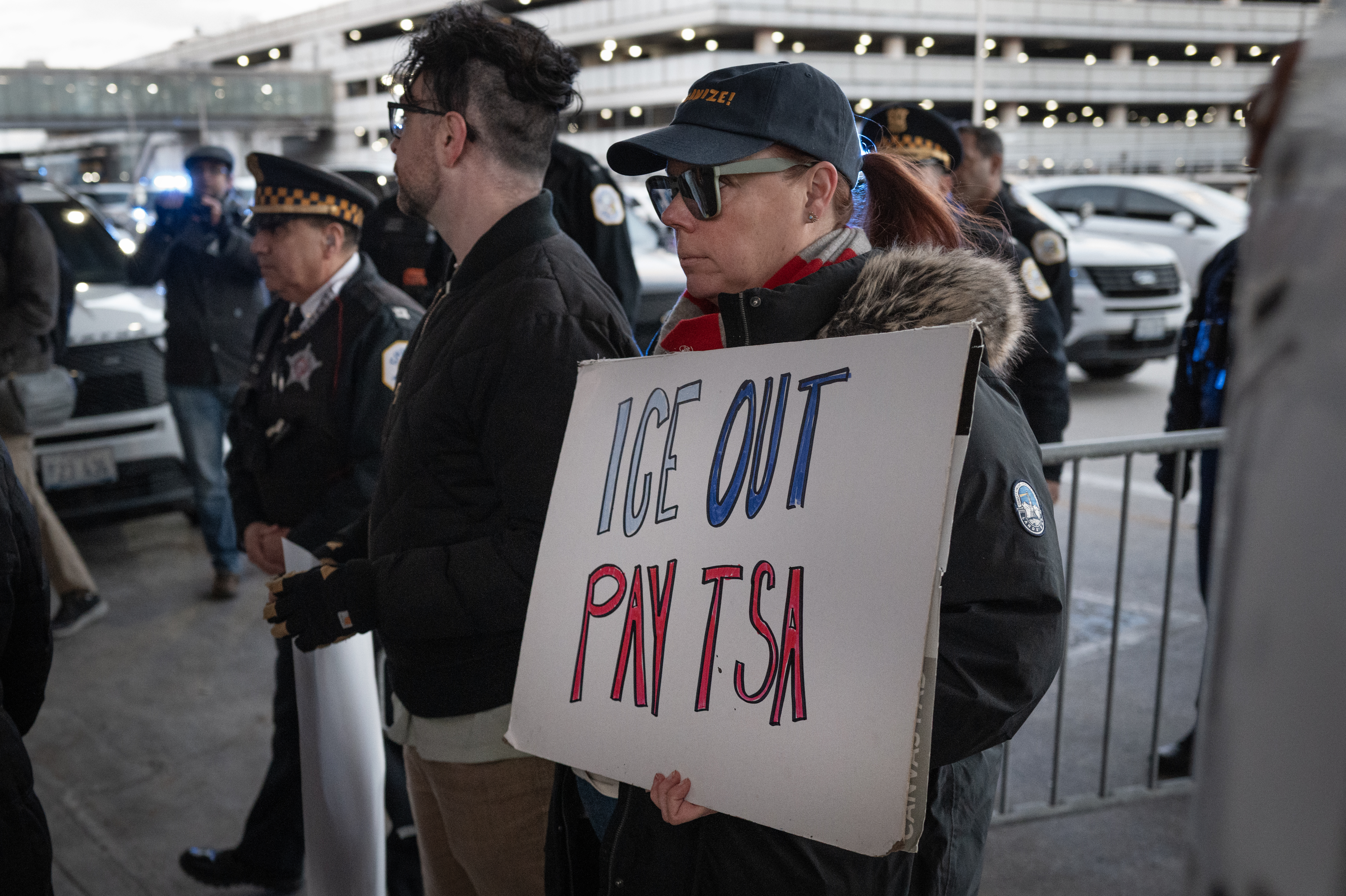 CHICAGO, ILLINOIS - MARCH 27: Demonstrators protest Department of Homeland Security assigning ICE agents to work alongside TSA agents at O&amp;apos;Hare International Airport on March 27, 2026 in Chicago, Illinois. The travel disruptions continue as hundreds of TSA agents quit or work without pay during a partial government shutdown. U.S. President Donald Trump said ICE agents will be deployed to U.S. airports on Monday, with border czar Tom Homan in charge of the effort. (Photo by Scott Olson/Getty Images)