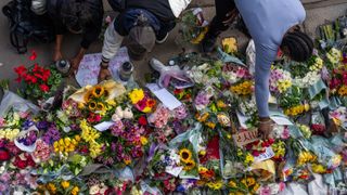 Members of the public lay flowers at the scene of Elianne Andam's murder in Croydon