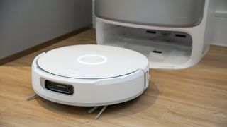 Narwal Flow robot vacuum next to its base