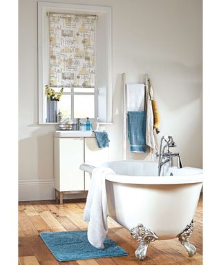 White freestanding bath with nautical blind design by English Blinds