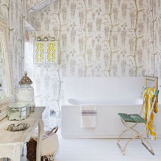 bathroom with rustic chair and floral wallpaper