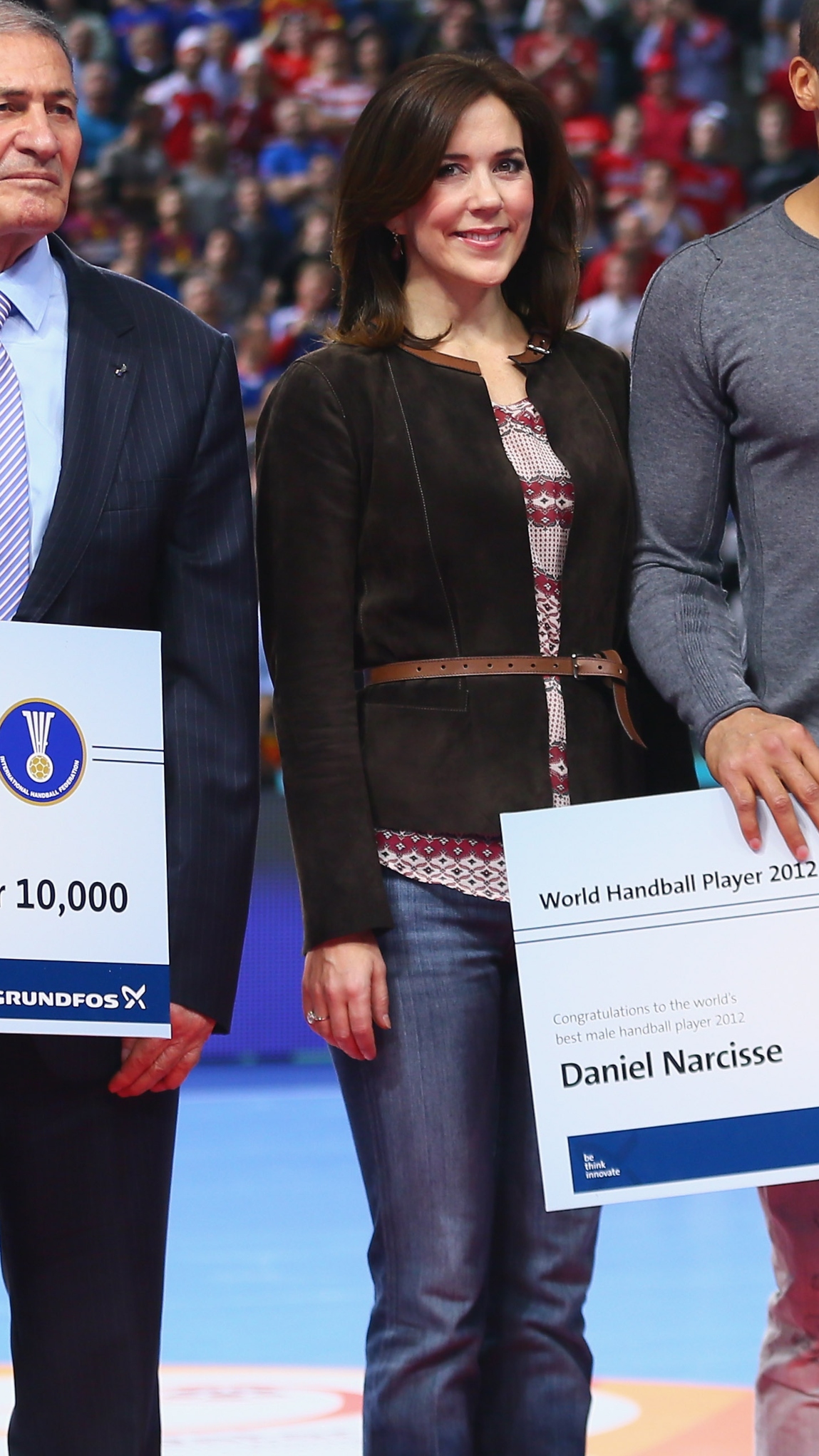 Queen Princess Mary of Denmark smiles and stands next to players holding cheques during the Men&#039;s Handball World Championship 2013 final match between Spain and Denmark at Palau Sant Jordi on January 27, 2013 in Barcelona, Spain.