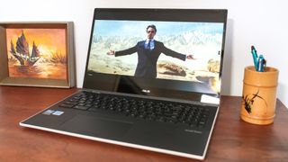 Asus Chromebook Flip CX5 (2022) open on desk showing Man of War playing