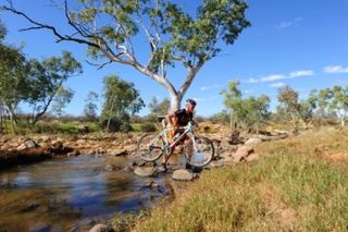 Brenton Jones (Team Torq) crosses a river in Alice Springs