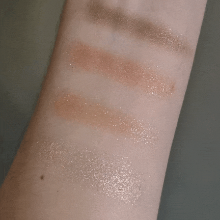 A gif showing Digital Beauty Writer, Naomi Jamieson, moving her arm to show the shimmer of the four Urban Decay Moondust eyeshadows swatched on her skin.