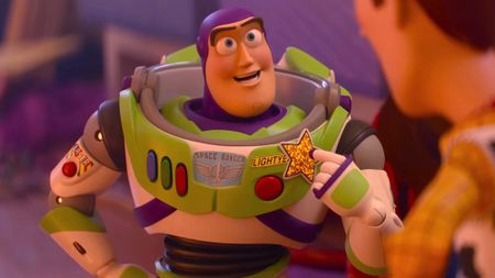 Buzz Lightyear points to a gold star on his chest in Toy Story 5.