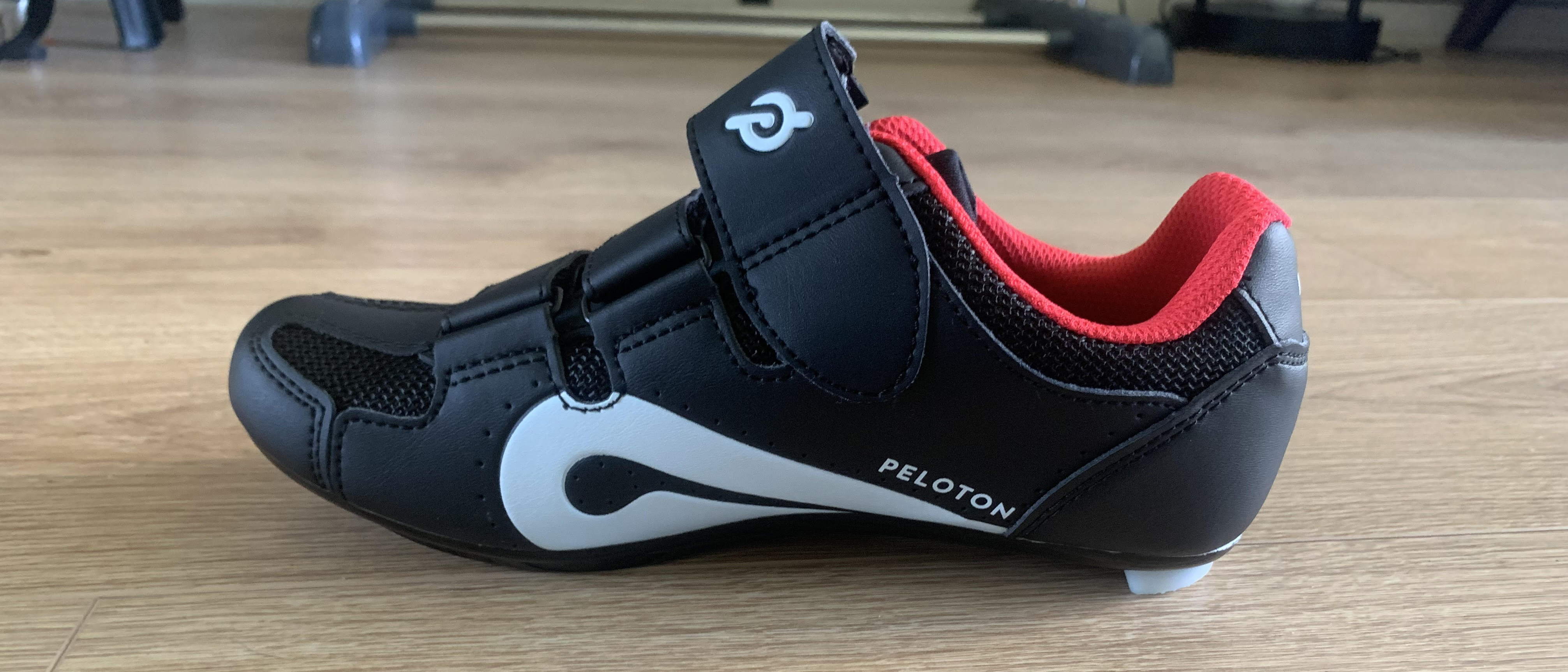 Peloton cycling shoes on wooden floor
