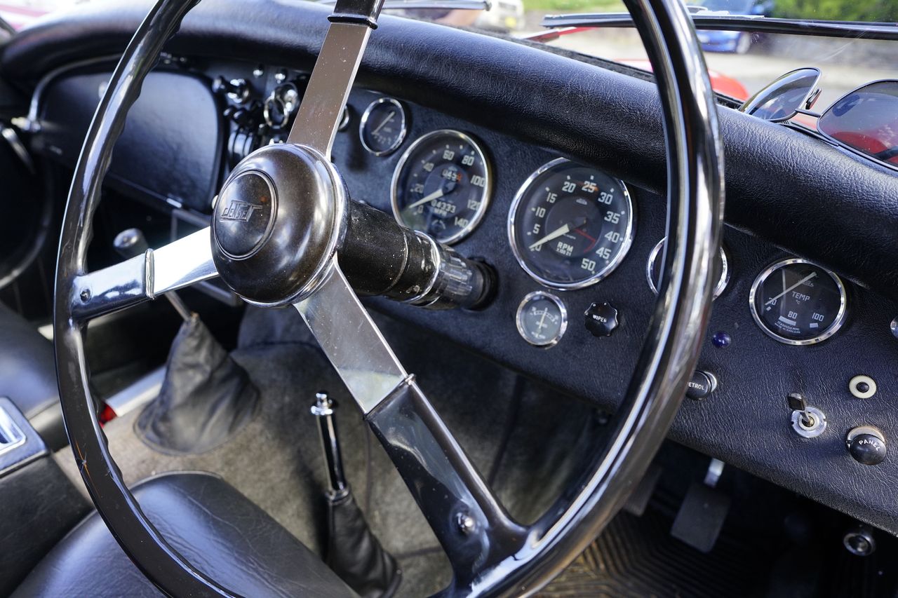 The steering wheel and dashboard of a classic car