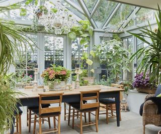 lean to conservatory with dining furniture filled with plants