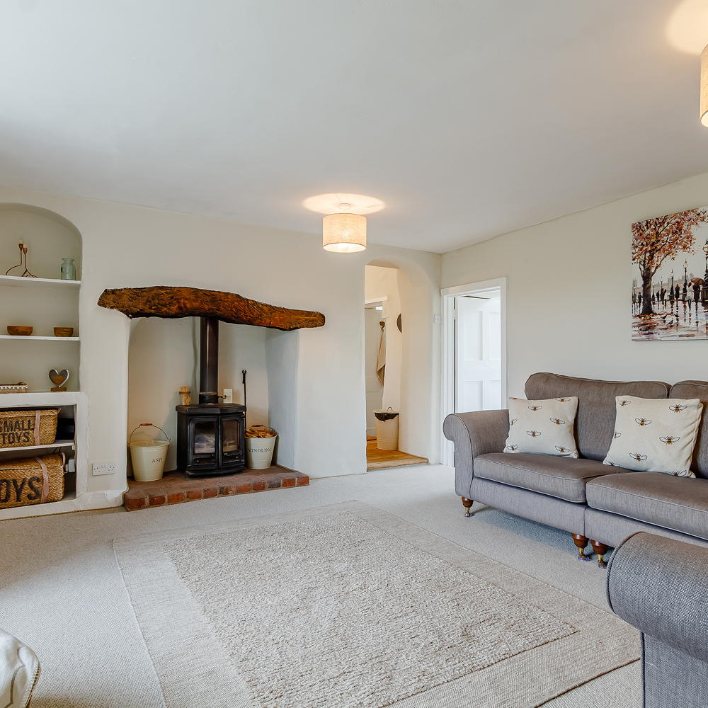 drawing room with rug on floor and sofaset with cushions