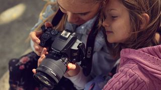 Best budget DSLRs - girls using a Canon EOS 250D