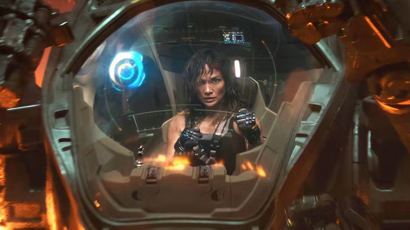 a woman in a cockpit pilots a giant exo-suit robot