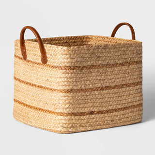 A water hyacinth basket with faux leather straps