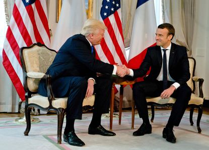 President Trump shakes hands with Emmanuel Macron in Brussels