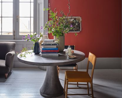 A red living room with a round desk table