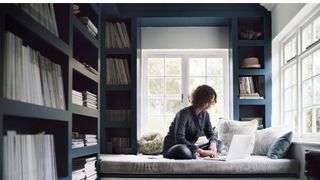 Woman working on window seat