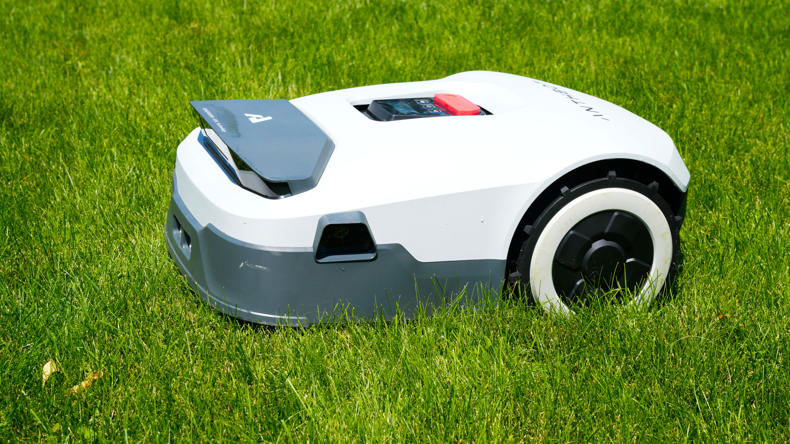 Anthbot Genie 3000 being tested in a bright green yard