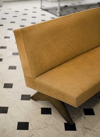A brown Pierre Jeanneret sofa at Saint Laurent Rive Droite