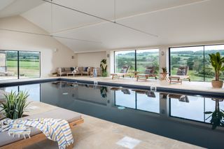Swimming pool with countryside views and seating around the edge