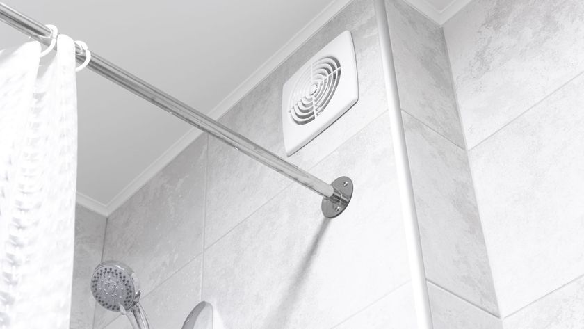 white bathroom extractor fan on wall above shower