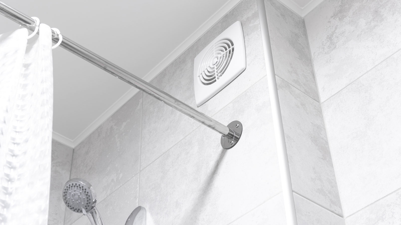 white bathroom extractor fan on wall above shower