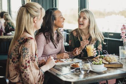 Women drinking in a restaurant as the rule on when pubs and restaurants can open indoors changes