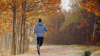 Rear view of man running in autumn