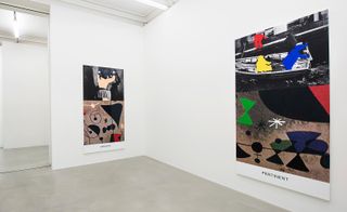 Two colourful paintings hang in a white gallery