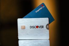 Capital One and Discover credit cards arranged in a wallet.