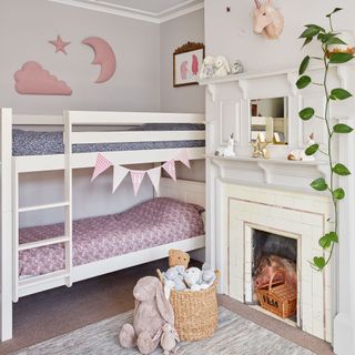 Child's bedroom with bunk beds, pink decor and unicorn head