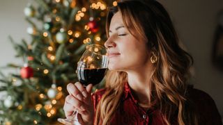 Woman drinking a glass of wine at Christmas