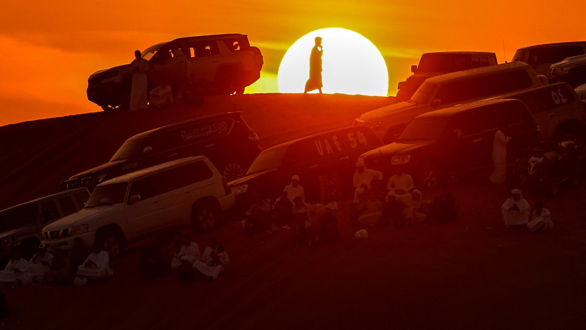 
                                People gather in the desert to watch cars dune drifting near Umm Al Quwain, United Arab Emirates
                            