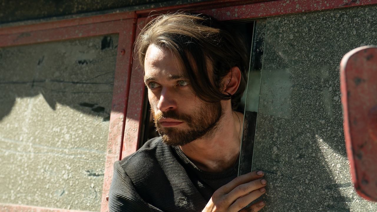 Link/Dylan leaning out of truck window in Paradise Season 2 finale