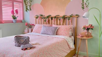 Colorful pink bed in green bedroom