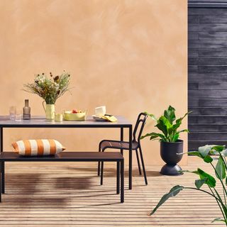 room with wooden flooring potted plant table with chair