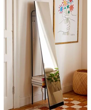 A tall full length mirror with storage at rear in hallway